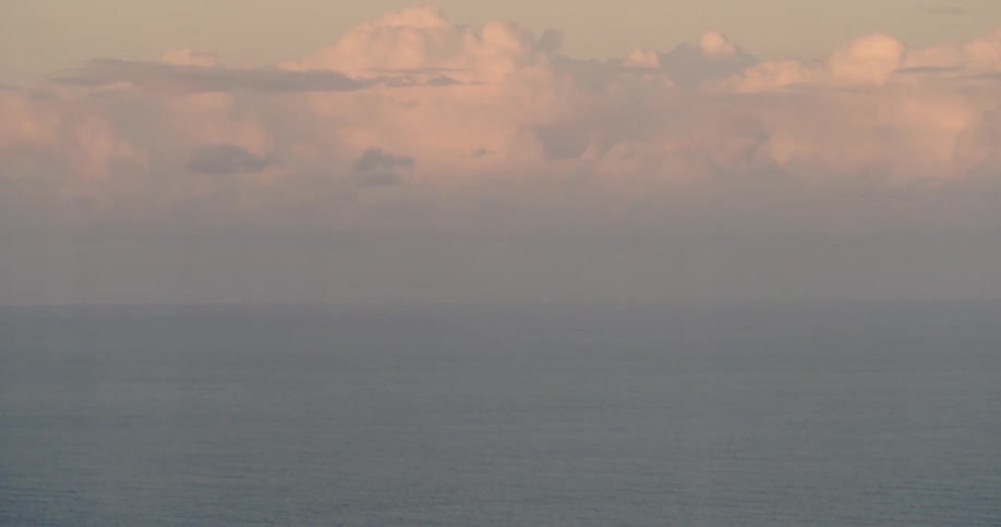 Clouds build over the ocean at sunrise
