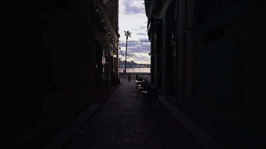 The alley is dark leading to the street