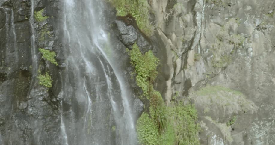 The waterfall is pouring heavy down the side of the rocks