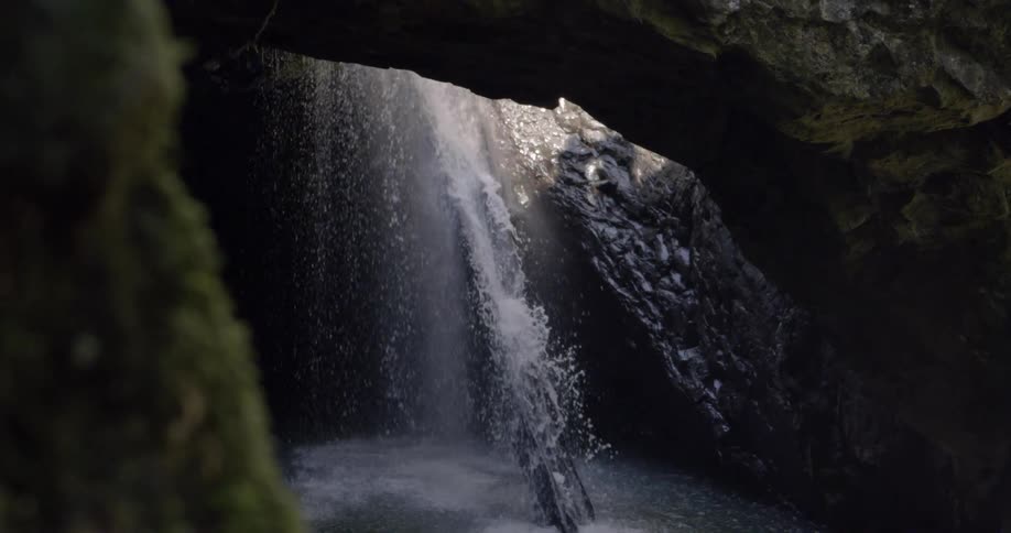 Waterfall splashing down into a cave