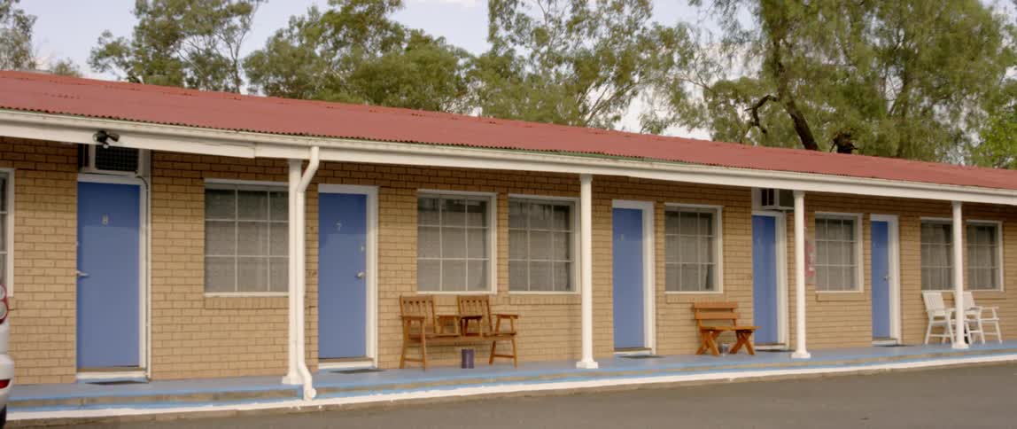 A row of houses have blue doors