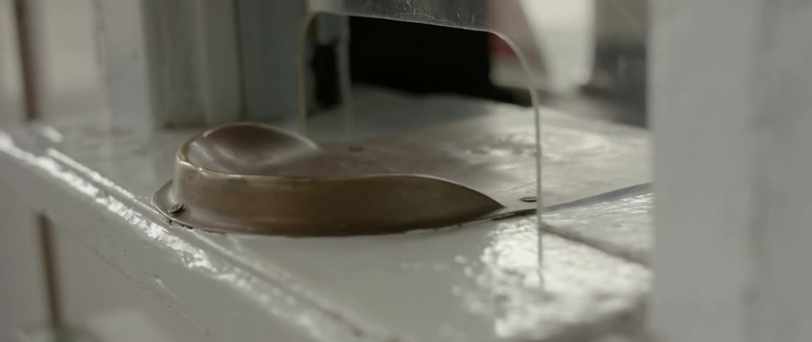 A coin lip sits just outside a plexiglass partition