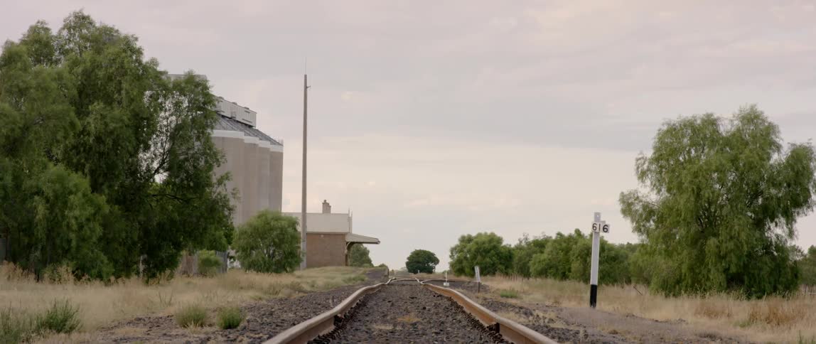 Train tracks run through a rural landscape