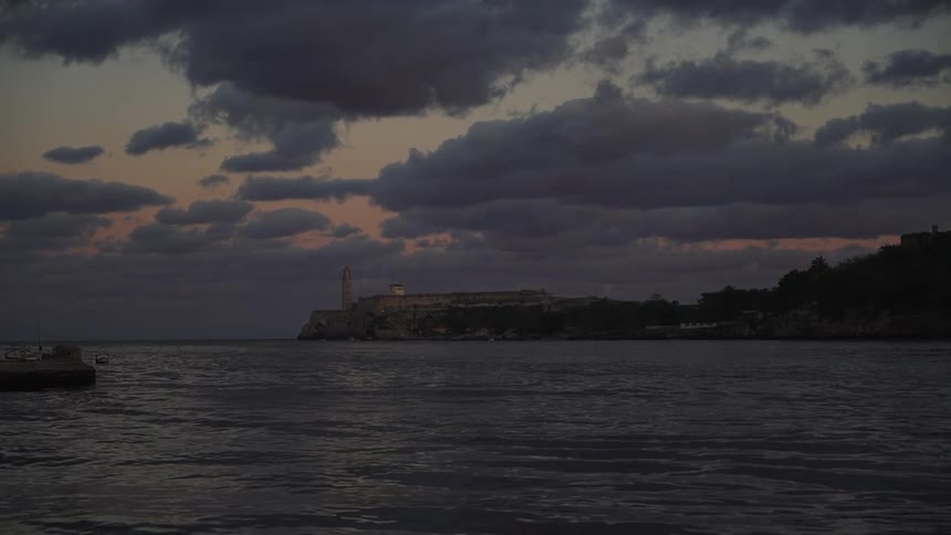 Lake on a cloudy evening with shoreline on the other side