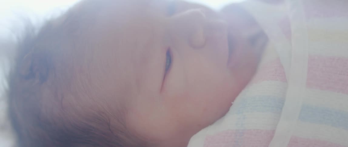 Close up of an infant's face on a sunny day