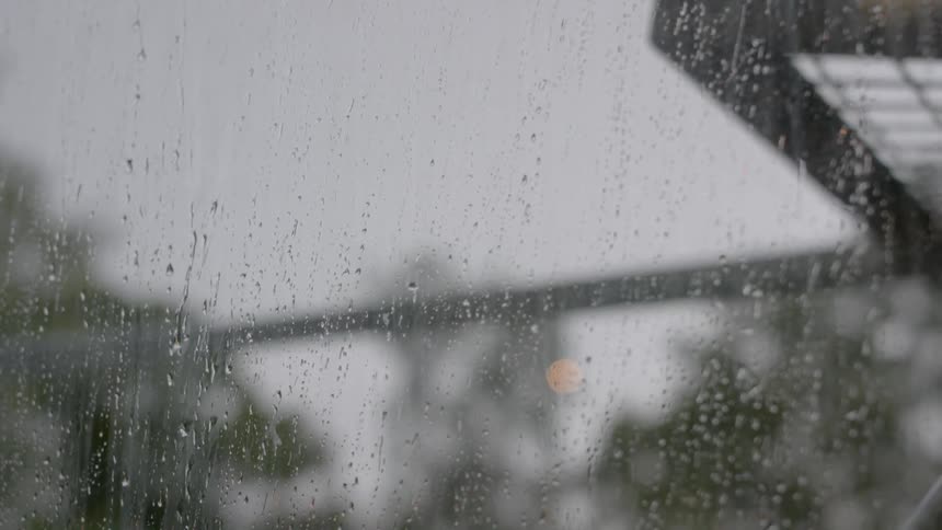 Rain slowly falls on the window
