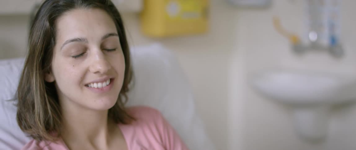 A woman is smiling then blinks