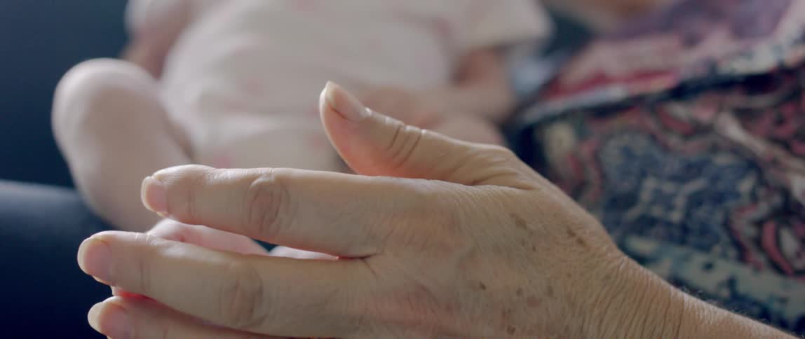 A person plays with a babies foot