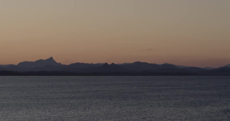The sun sets over a mountain lake