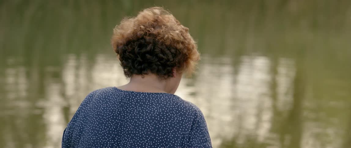 A woman looks out over the water