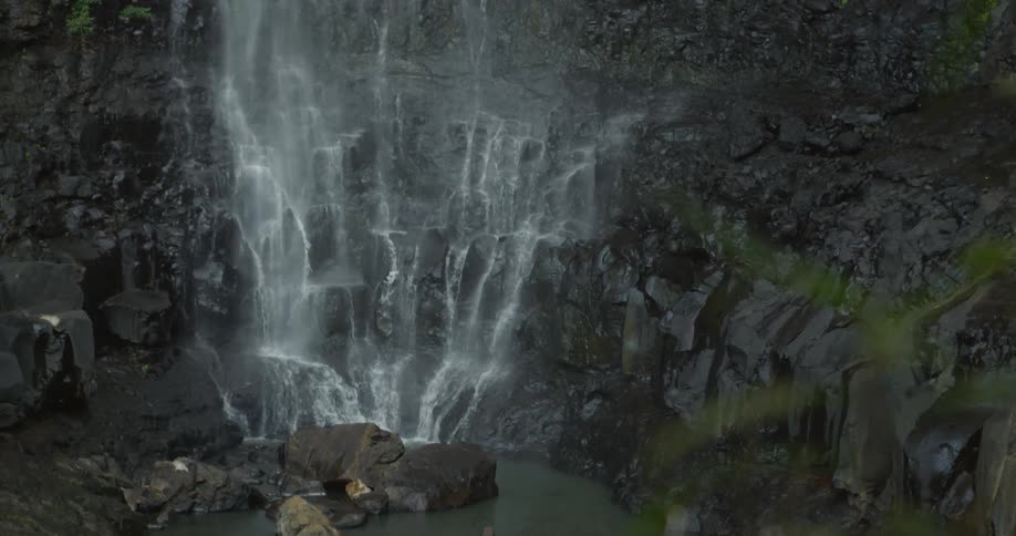 The waterfall is pouring over the edge of the cliff