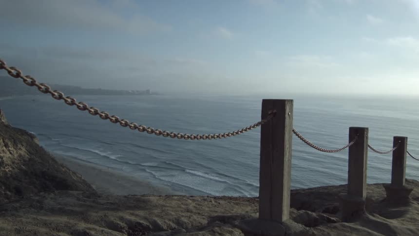 View of the ocean through a chain fence
