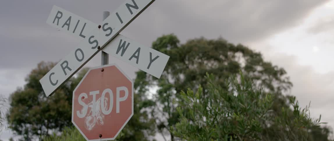 Stop and railway crossing signs in the country