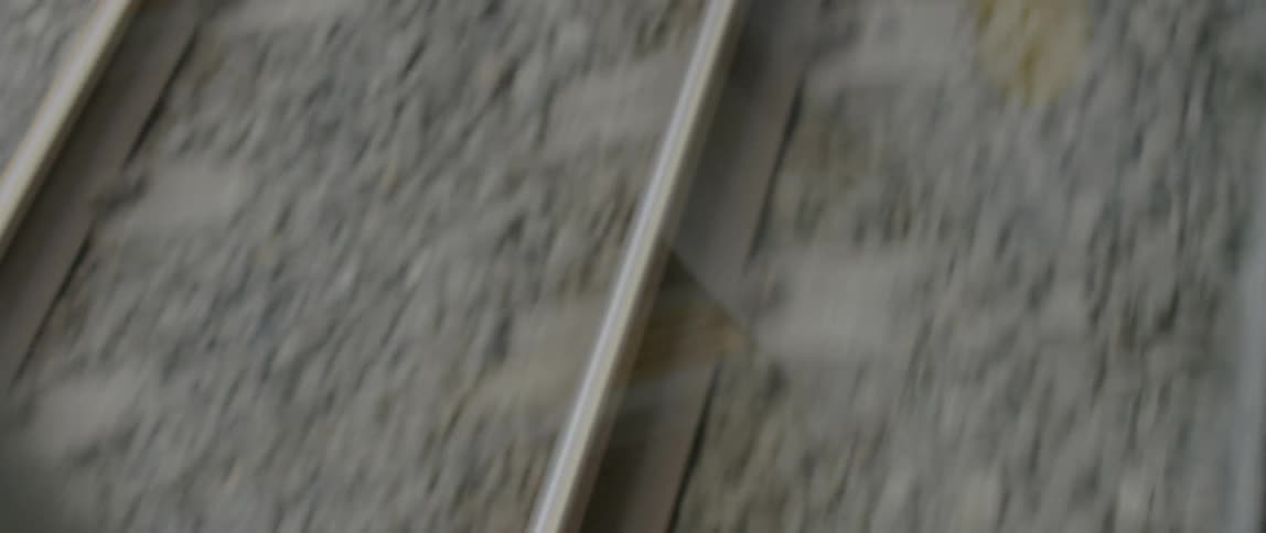 The rail and gravel of train tracks