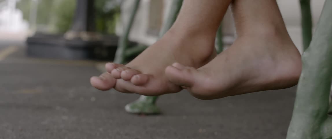 A child's feet dangle above the ground