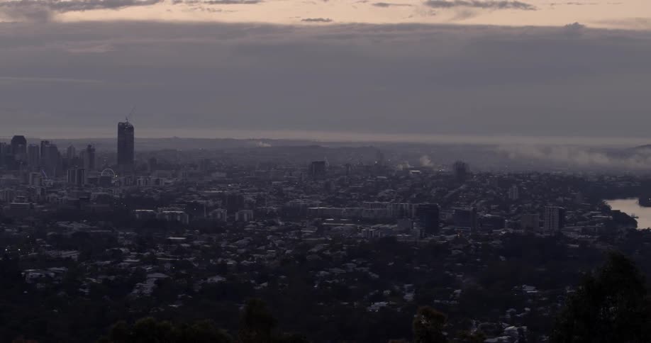 The city ahead has heavy clouds above