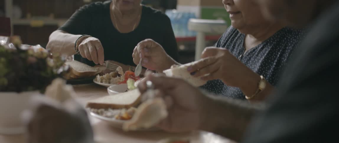People sit at a table and eat a meal