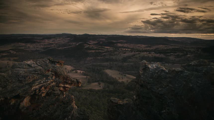 A mountainside area seen from above at dusk in a time lapse