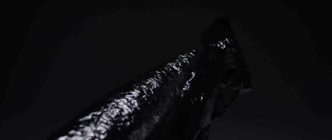Silver sheet blowing in a dark area