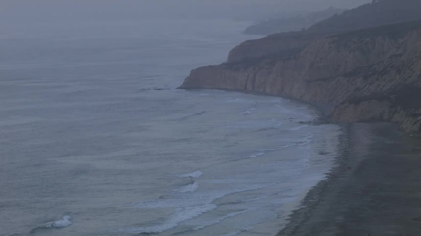 Small waves slowly coming ashore on a rocky beach