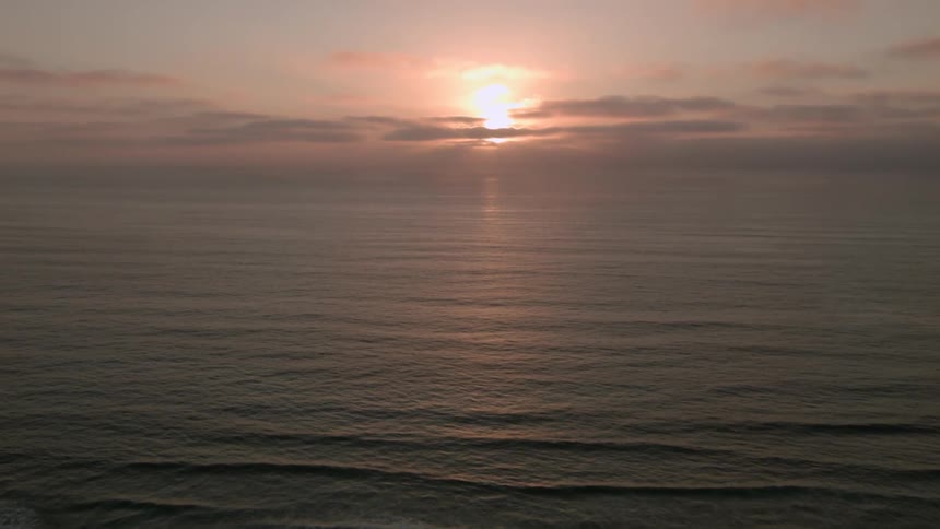A scenery of ocean at sunset time