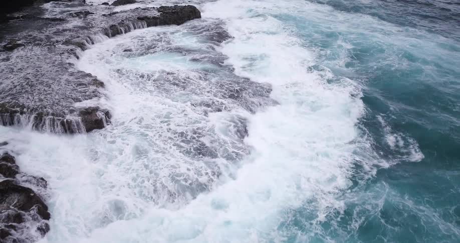 Waves crash and break on the rocks