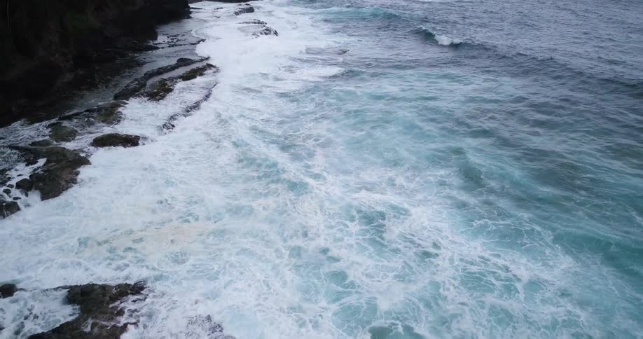 Ocean waves crashing to a rocky shore
