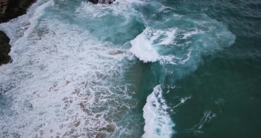 The waves slowly hit the shore below