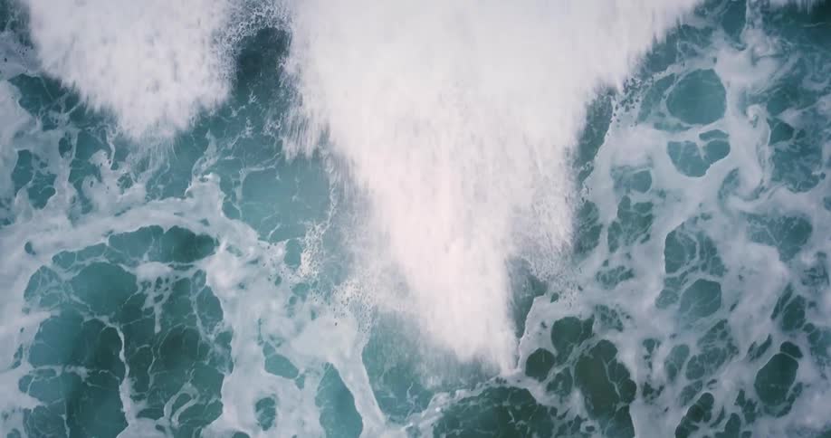 The blue waters are rough below with huge waves