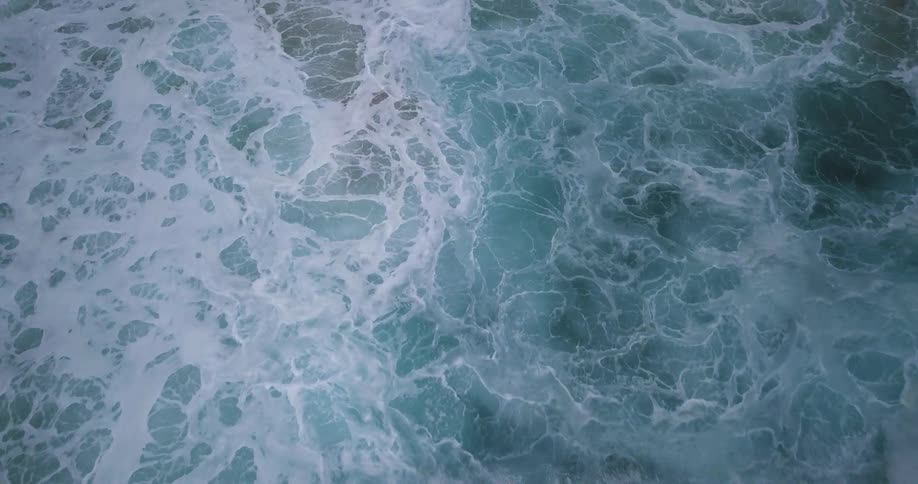 Ocean water ripples as a wave crashes down