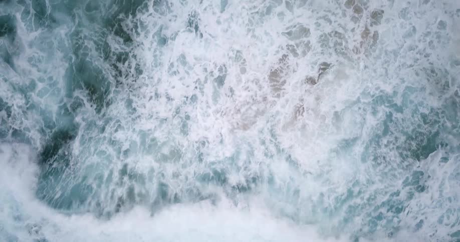 Ocean waves splashing and rolling to shore