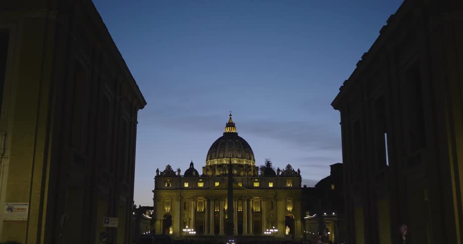 A domed building stands in a city at night