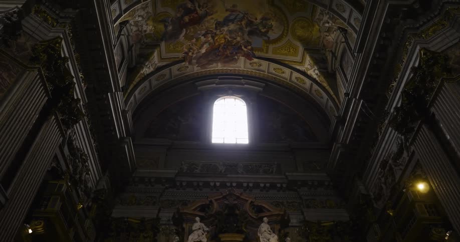 View of a cathedral ceiling and sun shining through a window