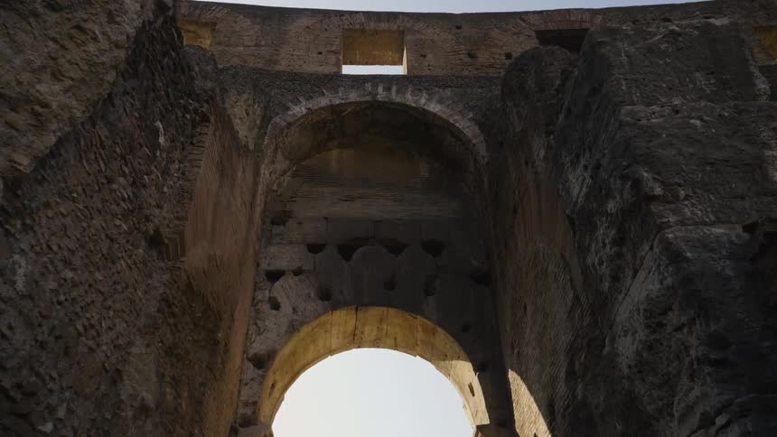 An arch of a stone structure stands overhead