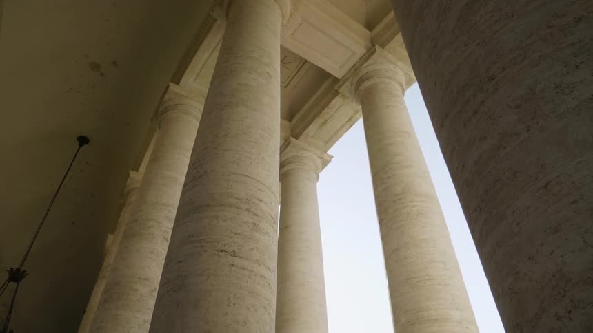 A light fixture hangs near the columns of a building