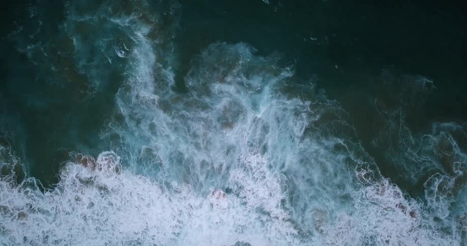 Ocean waves break and foam as they come to shore