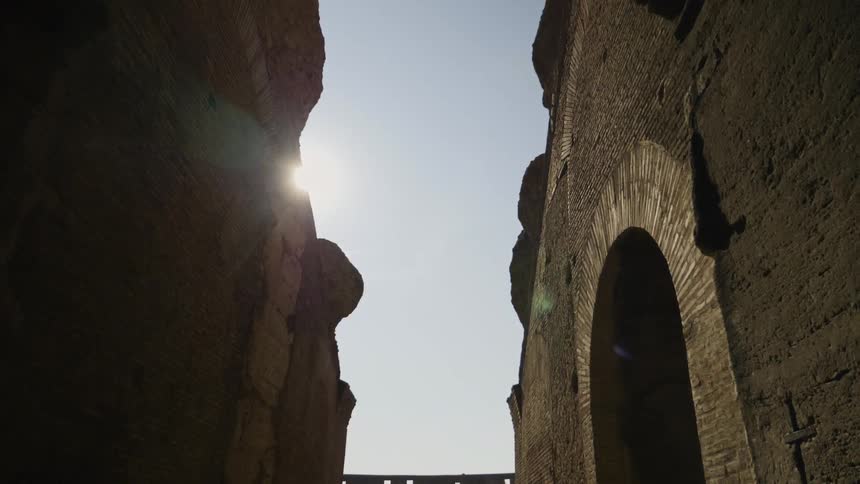 The sun shines down on stone buildings