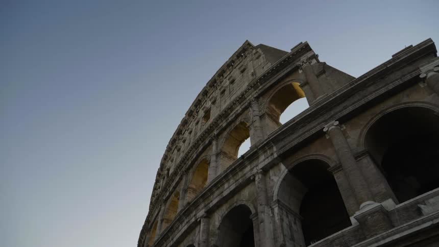 An ancient roman ruin stands against the blue sky