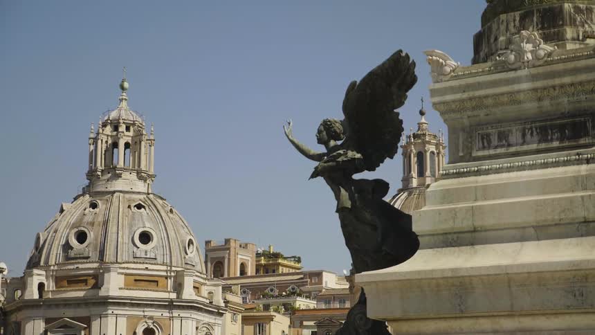 An angel statue sits on a stone building