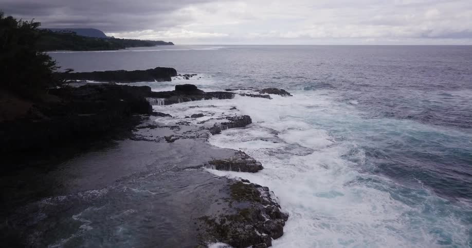 The shore has many rough waves hitting