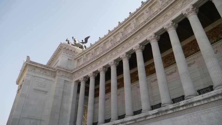 A large statue is at the top of this building