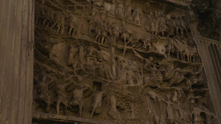The stone wall is full of carvings