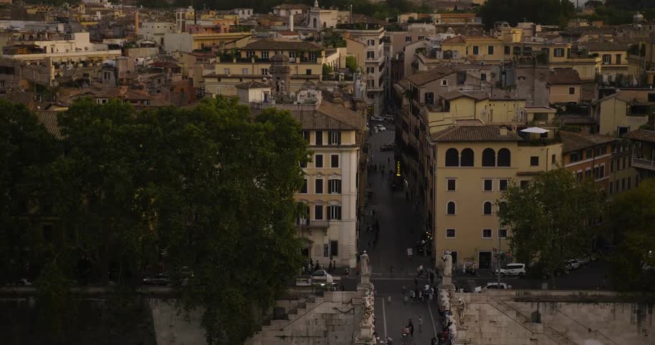 Cars and people travel around the town below