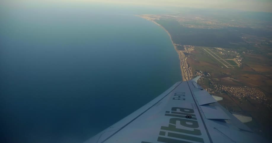 A plane is traveling over the coast