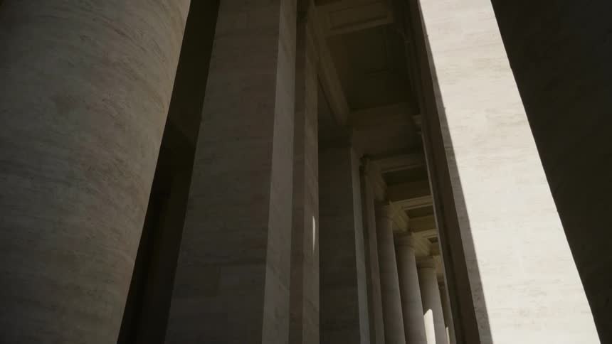 The building is lined with tall stone pillars