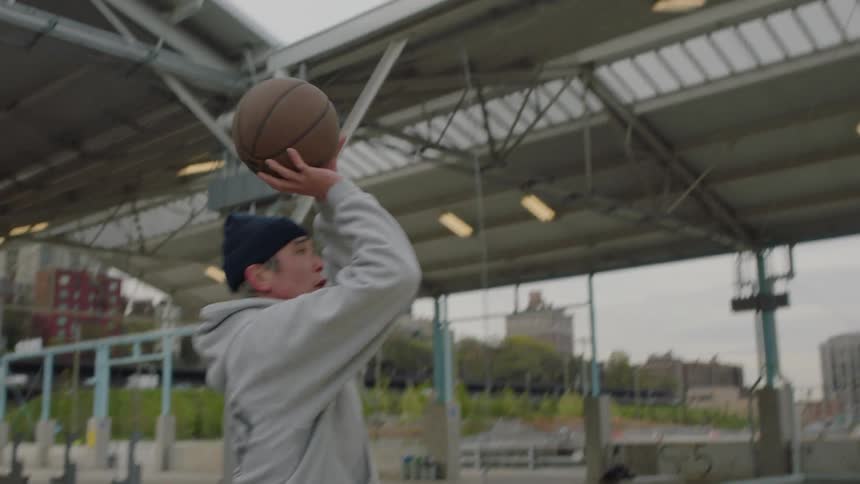 Men play basketball on an outdoor court