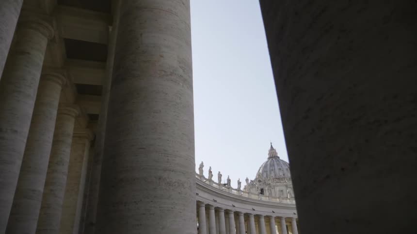 A line of pillars stand on a building exterior