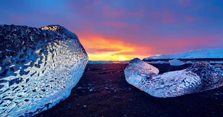The sun is almost set on this shore covered with ice