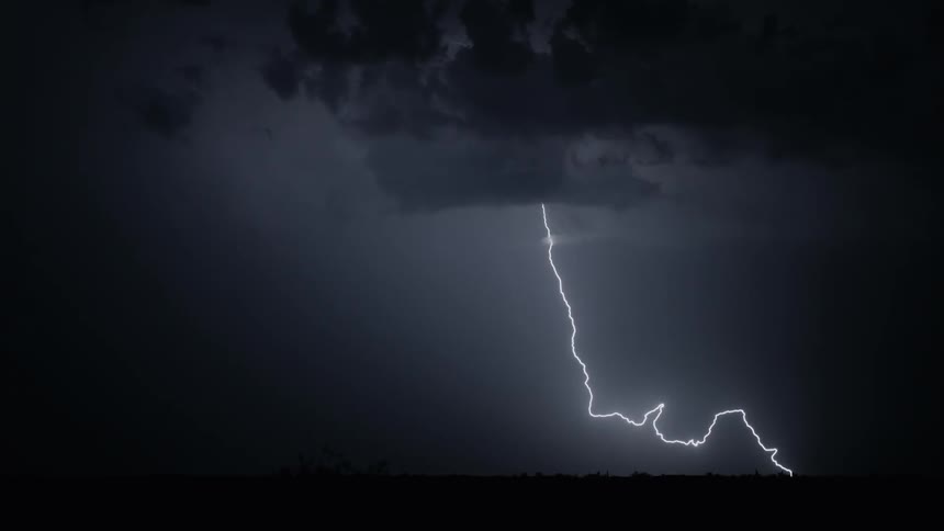 Lightning flashes out of a cloud towards the ground