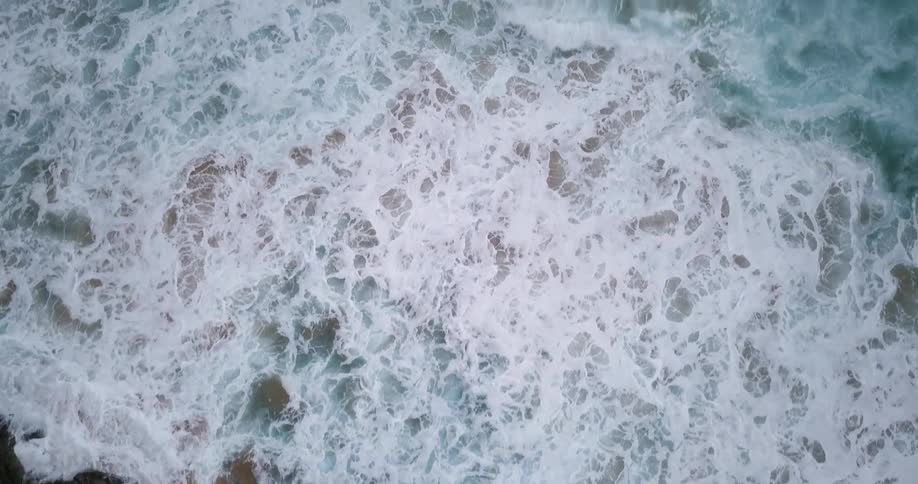 Waves move fast crashing against the shore